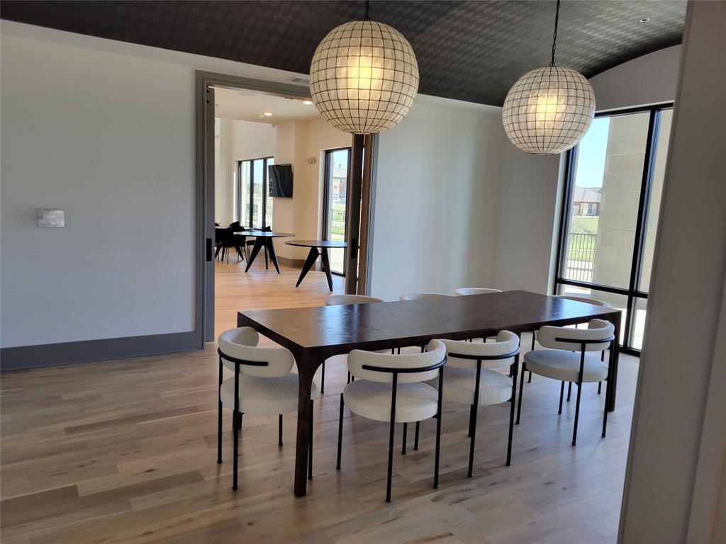 2700 Old Denton Road, Unit 4407 Carrollton, TX 75007 - Photo 25 of 34 a dining room with furniture a chandelier and wooden floor