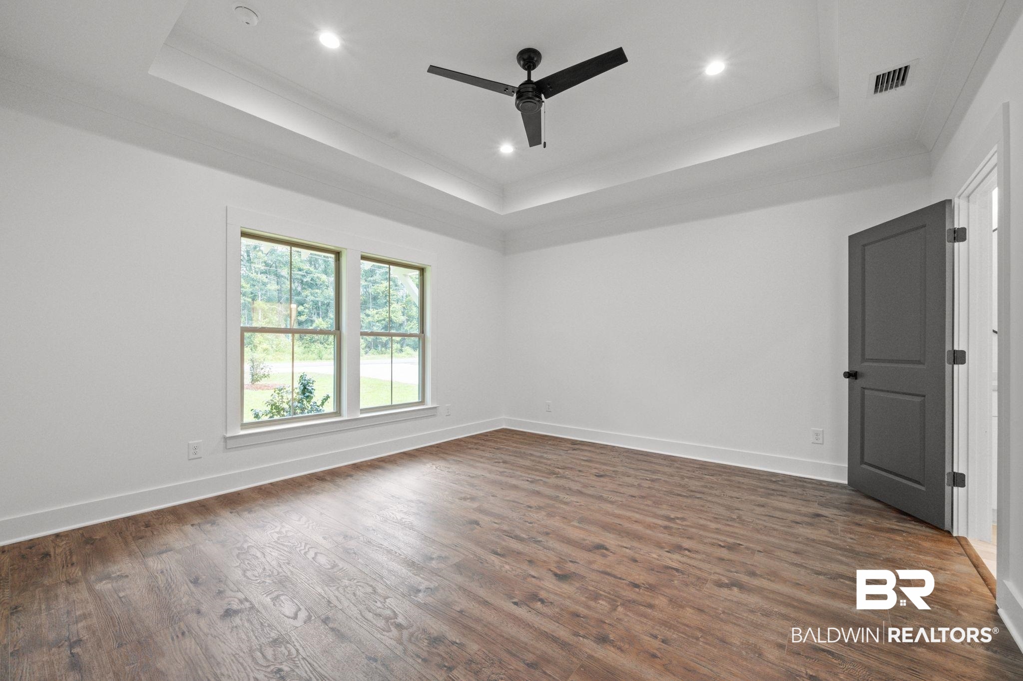 12412 Mannich Lane Foley, AL 36535 - Photo 12 of 23 featuring dark hardwood / wood-style flooring, ornamental molding, a raised ceiling, and ceiling fan