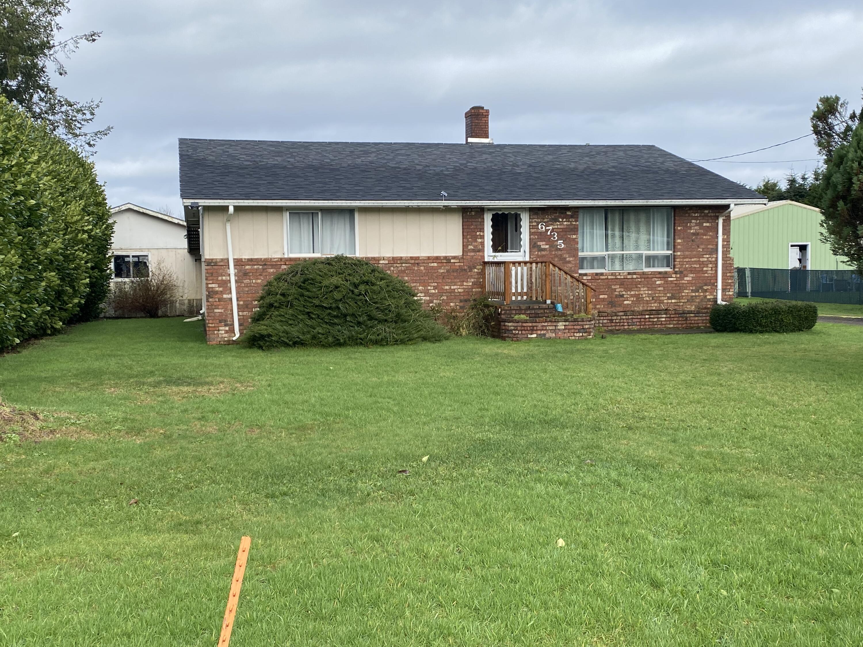 6735 South Prairie Road Tillamook, OR 97141 - Photo 20 of 23 a front view of a house with a garden