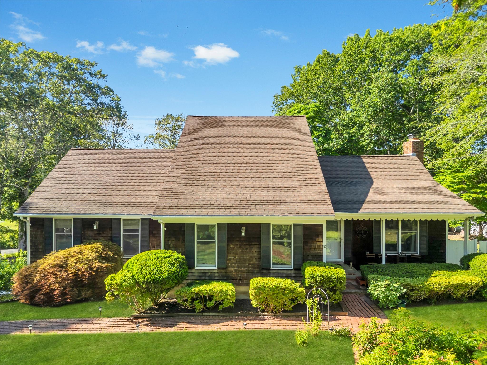a front view of house with yard and green space