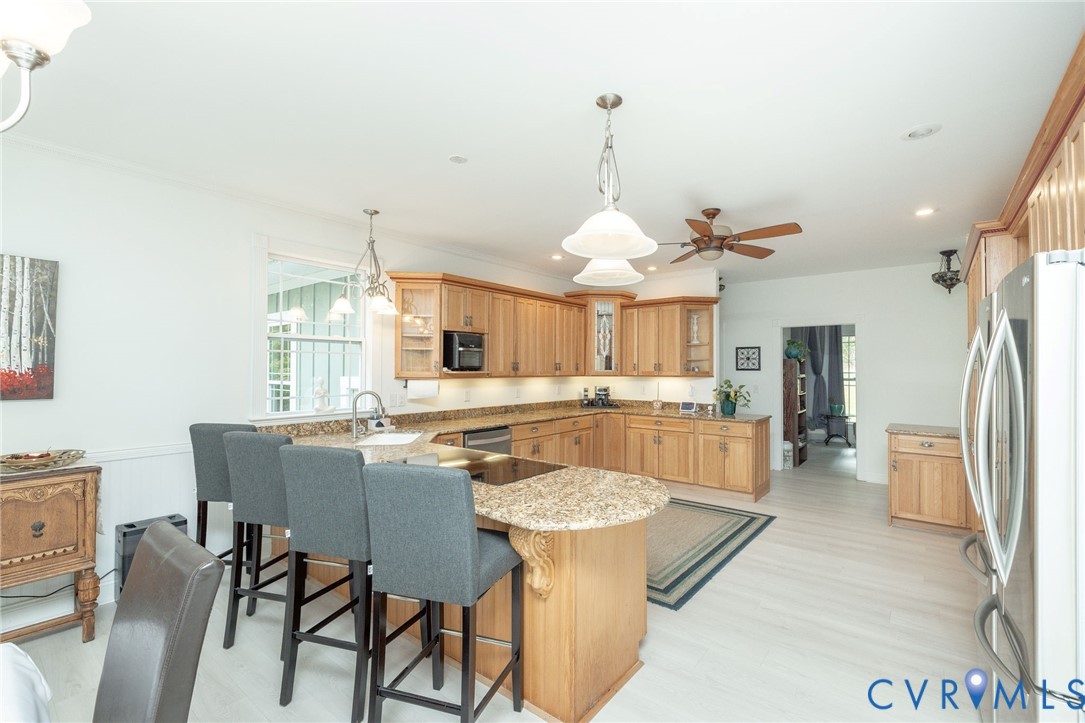 11081 Shannon Hill Road Louisa, VA 23093 - Photo 12 of 49 a dining room with stainless steel appliances kitchen island a table and chairs