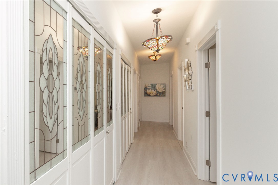 11081 Shannon Hill Road Louisa, VA 23093 - Photo 16 of 49 a view of a hallway with a chandelier