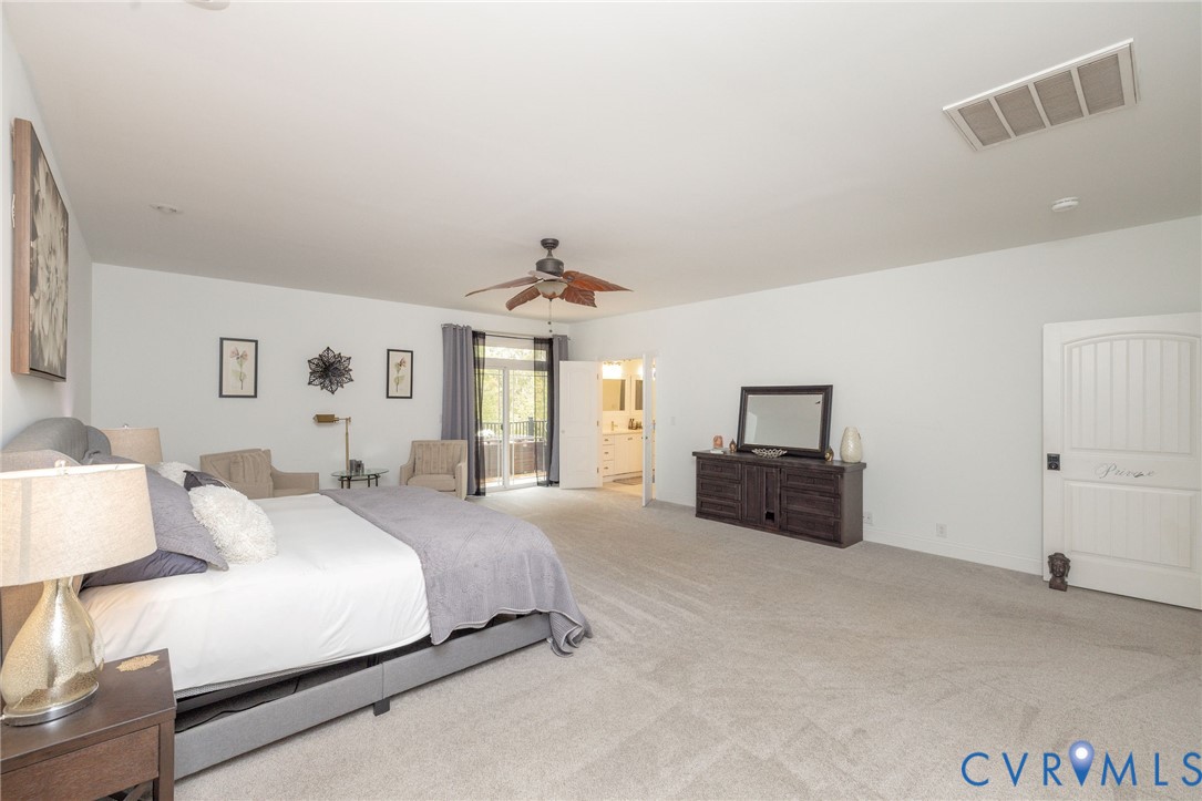 11081 Shannon Hill Road Louisa, VA 23093 - Photo 18 of 49 a spacious bedroom with a bed and a couch