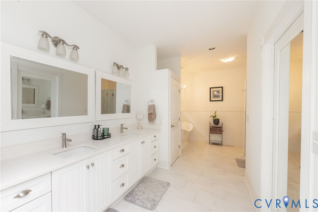 11081 Shannon Hill Road Louisa, VA 23093 - Photo 20 of 49 a spacious bathroom with sinks mirror and a shower