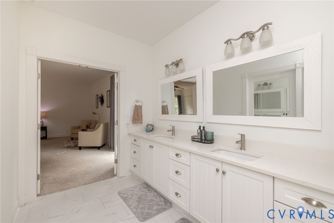 11081 Shannon Hill Road Louisa, VA 23093 - Photo 21 of 49 a en suite bathroom with double sink and a mirror