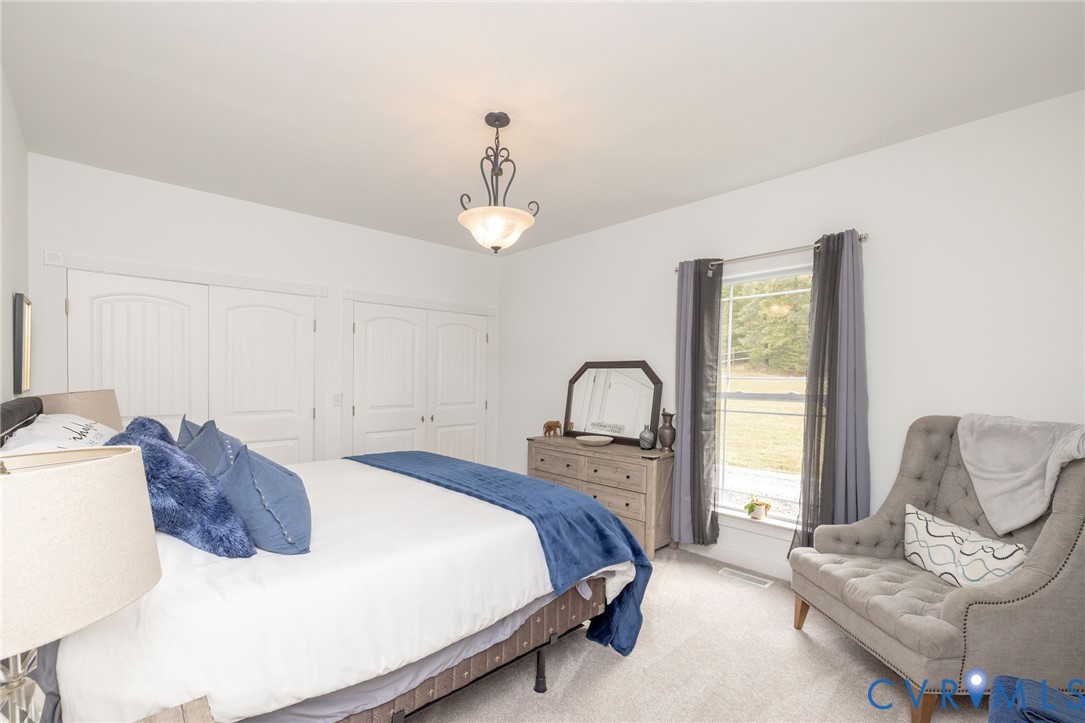 11081 Shannon Hill Road Louisa, VA 23093 - Photo 26 of 49 a bedroom with a bed couch and window
