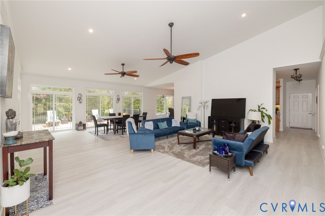 11081 Shannon Hill Road Louisa, VA 23093 - Photo 6 of 49 a living room with furniture a ceiling fan and a flat screen tv