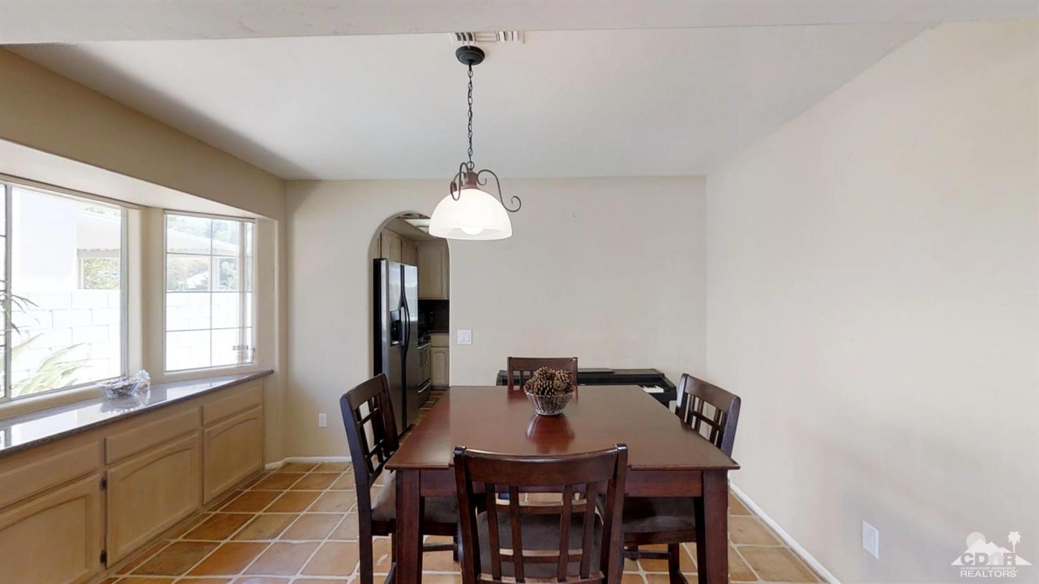 68261 Durango Road Cathedral City, CA 92234 - Photo 14 of 43 a view of a dining room with furniture window and outside view