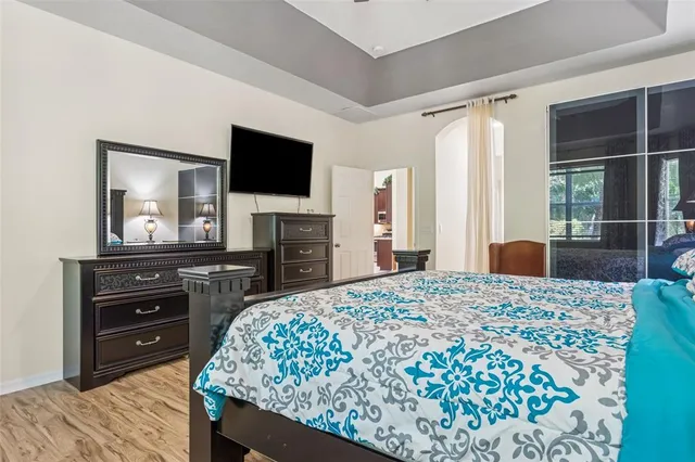 a spacious bathroom with a granite countertop double vanity sink a mirror and a bathtub