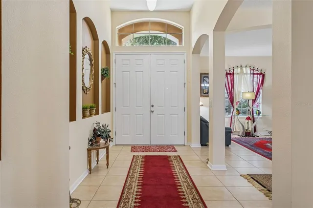 a living room with furniture a flat screen tv and a table