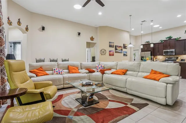 a dining room with furniture and a kitchen view