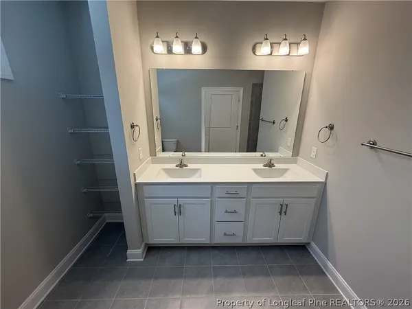 a bathroom with a double vanity sink and mirror