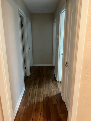 a view of a room with wooden floor
