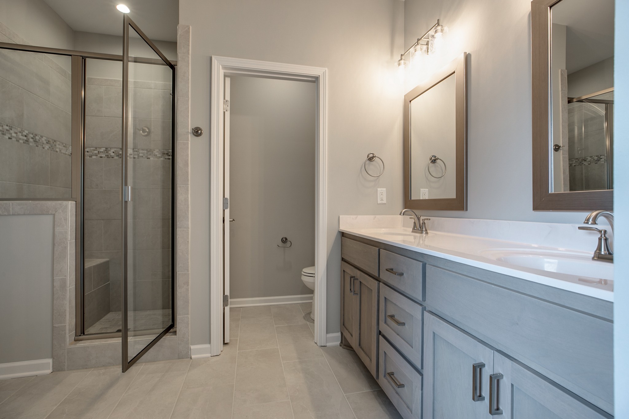 248 Doak Road Manchester, TN 37355 - Photo 13 of 23 a spacious bathroom with a double vanity sink a mirror and a shower