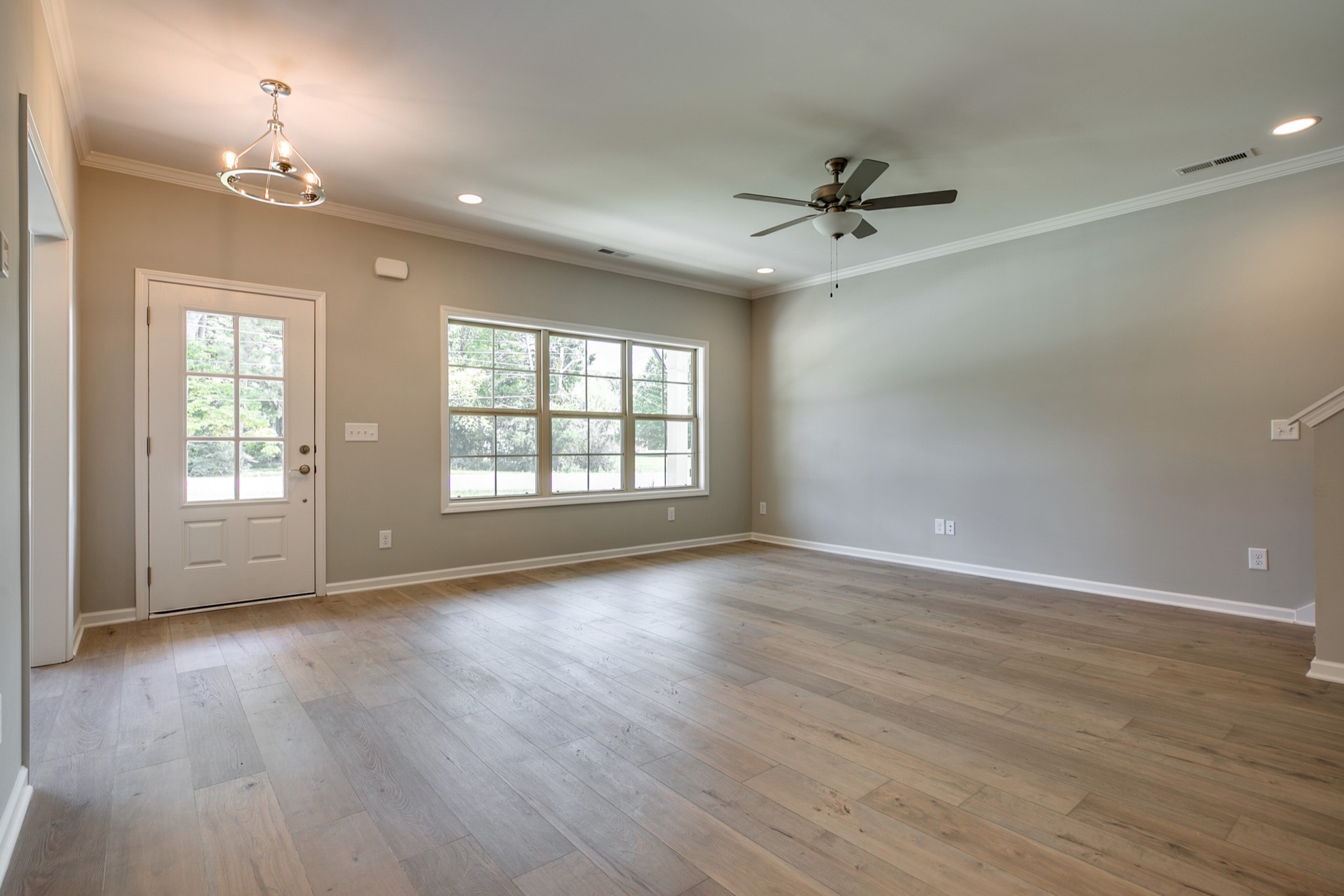 248 Doak Road Manchester, TN 37355 - Photo 5 of 23 an empty room with wooden floor ceiling fan and windows