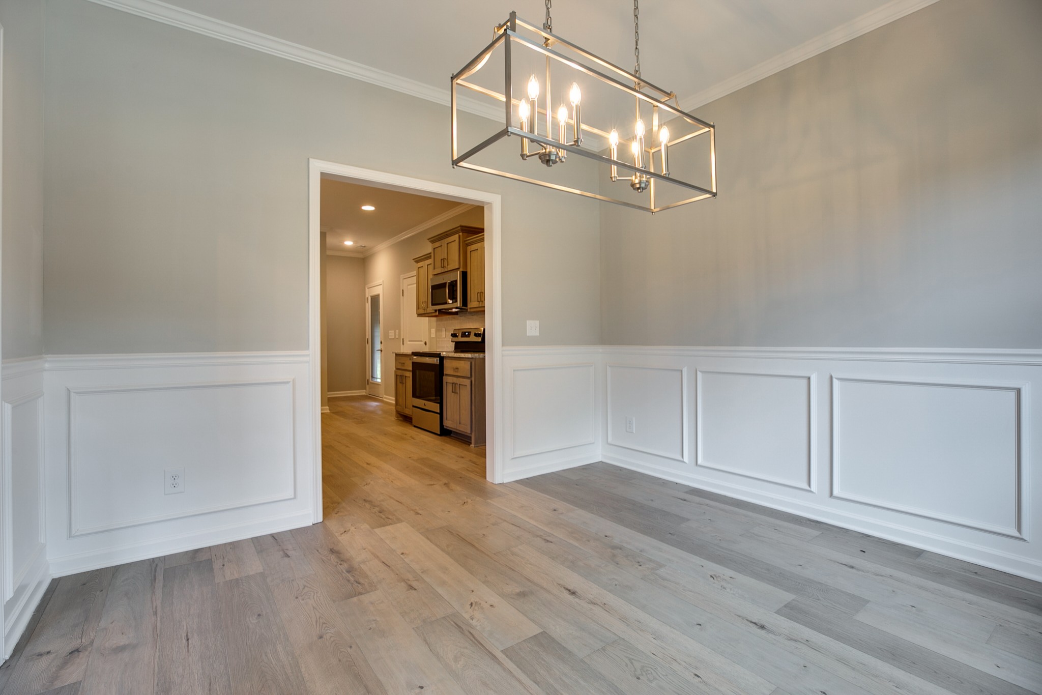248 Doak Road Manchester, TN 37355 - Photo 9 of 23 an empty room with wooden floor chandelier and windows