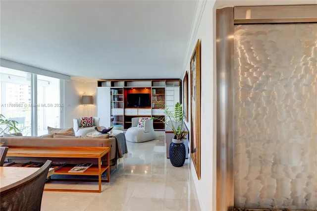 a living room with furniture a flat screen tv and a floor to ceiling window