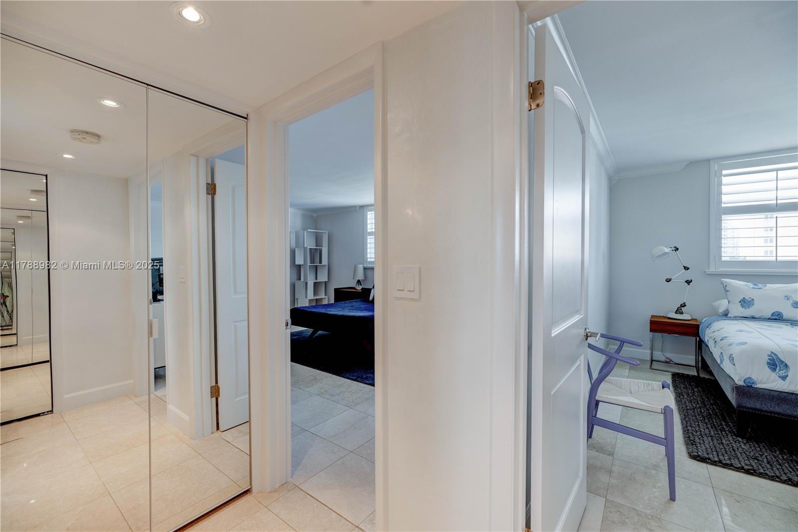 609 Ocean Drive, Unit 6H Key Biscayne, FL 33149 - Photo 14 of 32 a en suite bathroom with a sink and a mirror