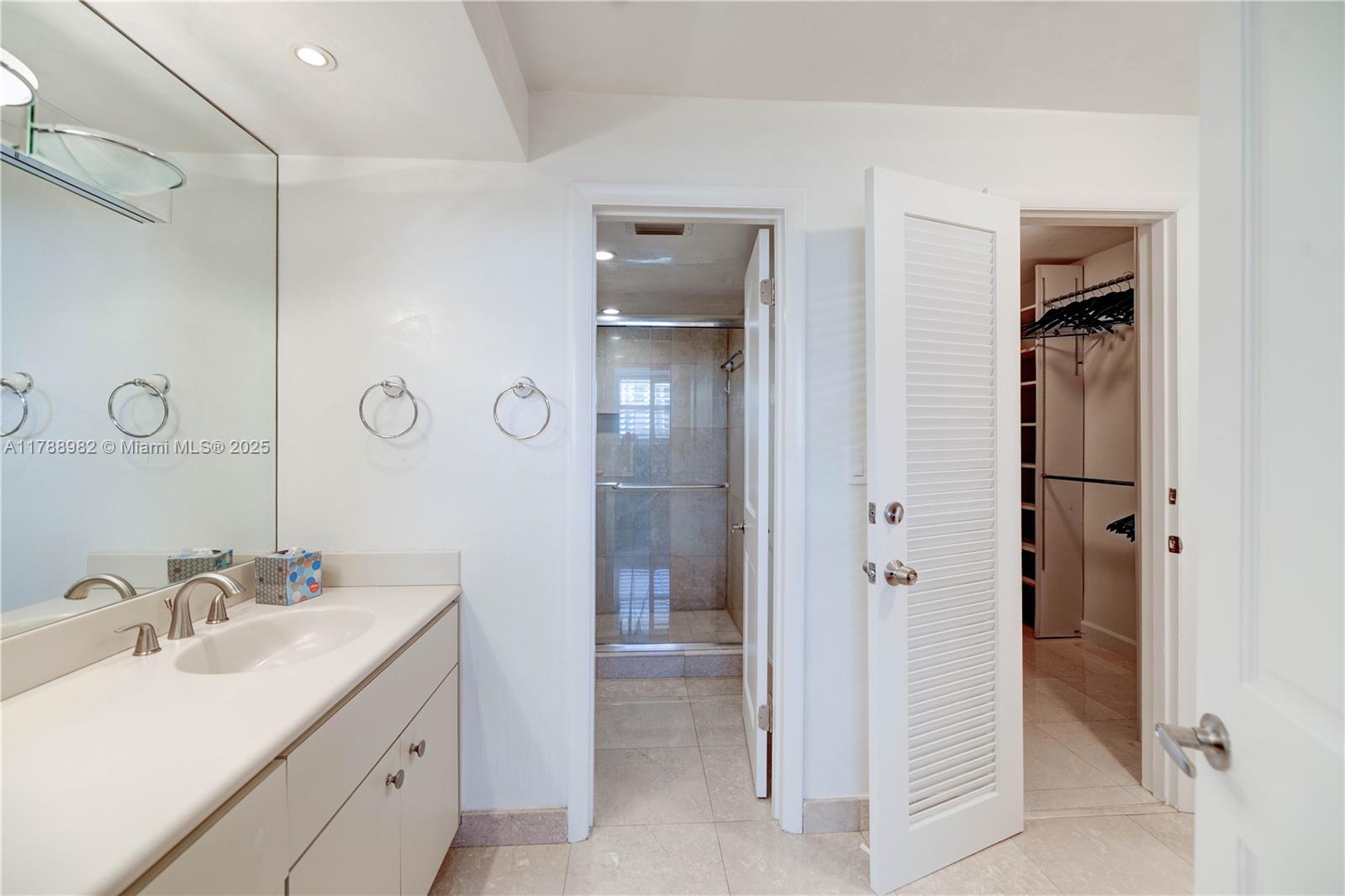 609 Ocean Drive, Unit 6H Key Biscayne, FL 33149 - Photo 17 of 32 a bathroom with a double vanity sink and mirror
