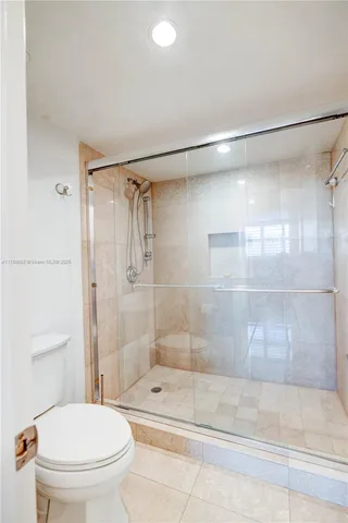 a bathroom with a shower a toilet and a sink