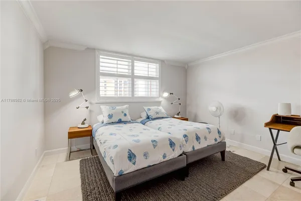 a bedroom with a bed a table and chair