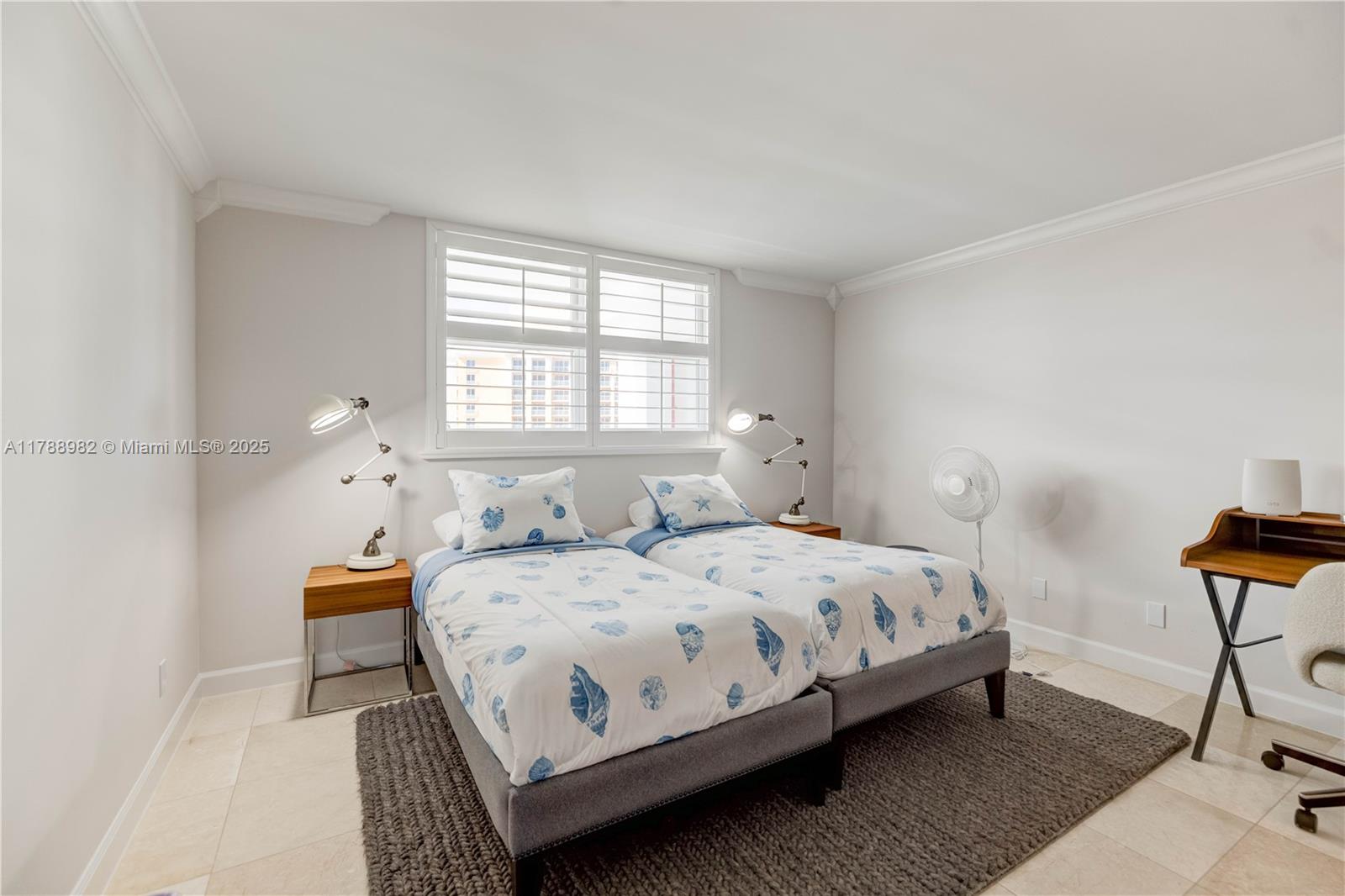 609 Ocean Drive, Unit 6H Key Biscayne, FL 33149 - Photo 21 of 32 a bedroom with a bed a table and chair