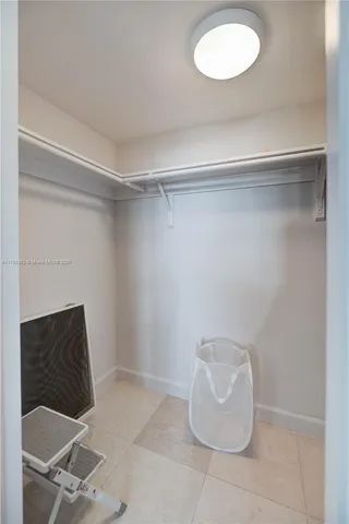 a room with a chair and potted plant