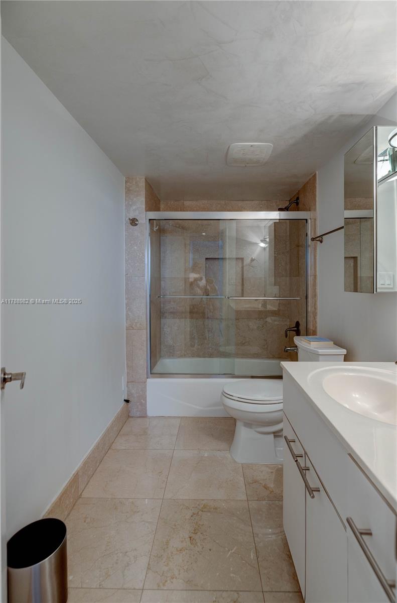 609 Ocean Drive, Unit 6H Key Biscayne, FL 33149 - Photo 24 of 32 a bathroom with a shower a sink and a toilet
