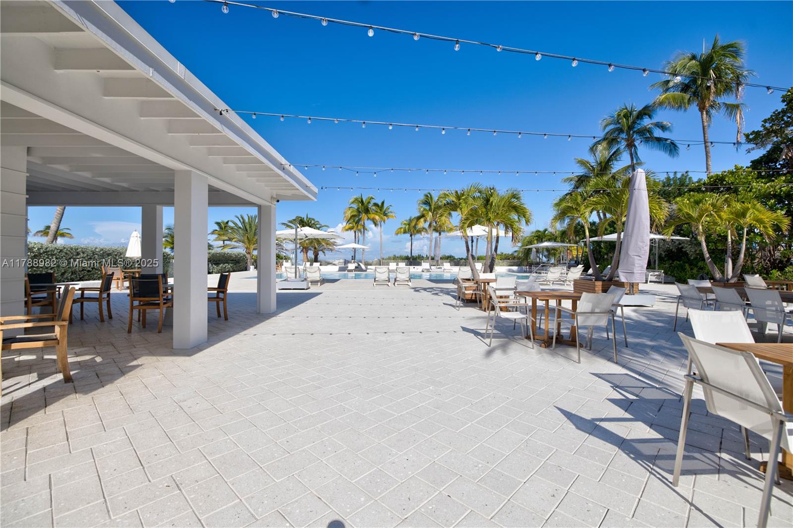 609 Ocean Drive, Unit 6H Key Biscayne, FL 33149 - Photo 28 of 32 a view of a swimming pool with outdoor seating