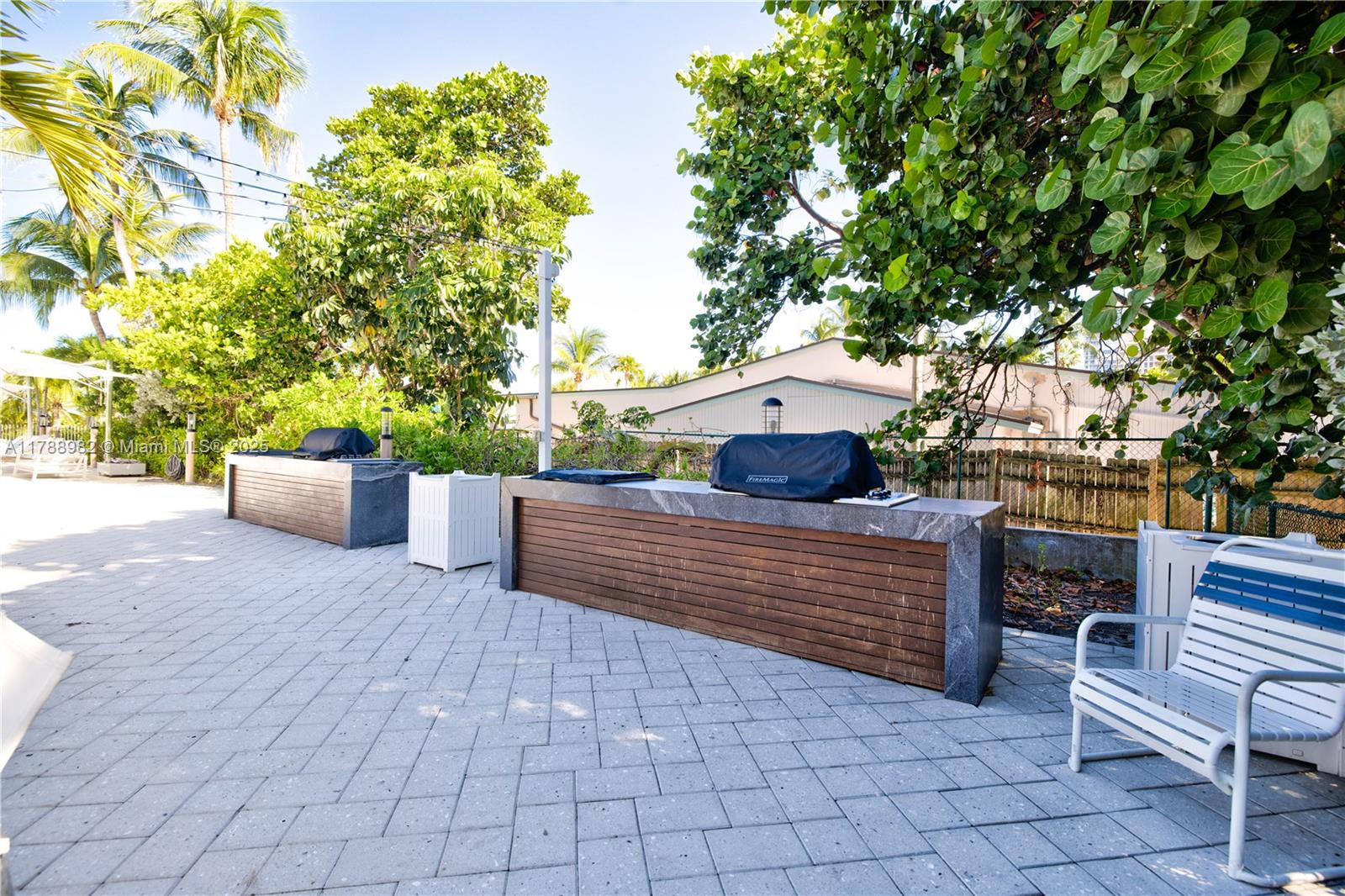 609 Ocean Drive, Unit 6H Key Biscayne, FL 33149 - Photo 30 of 32 a view of a bench in the backyard