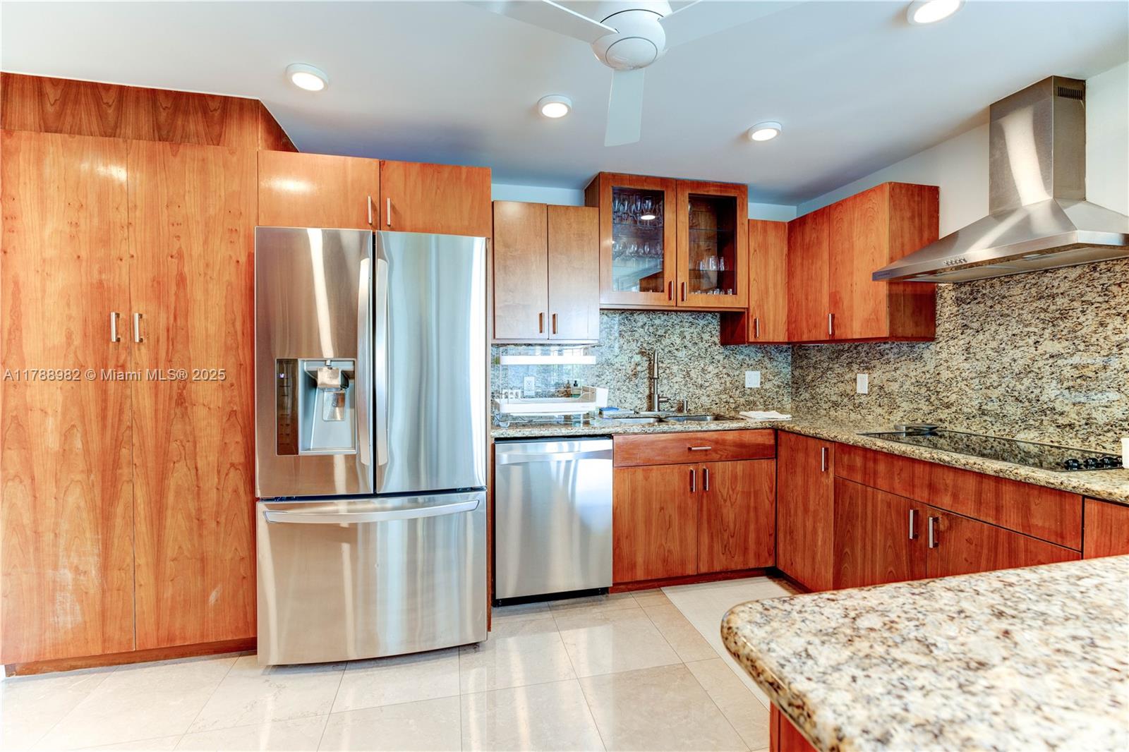 609 Ocean Drive, Unit 6H Key Biscayne, FL 33149 - Photo 6 of 32 a kitchen with stainless steel appliances granite countertop a refrigerator a sink and a stove