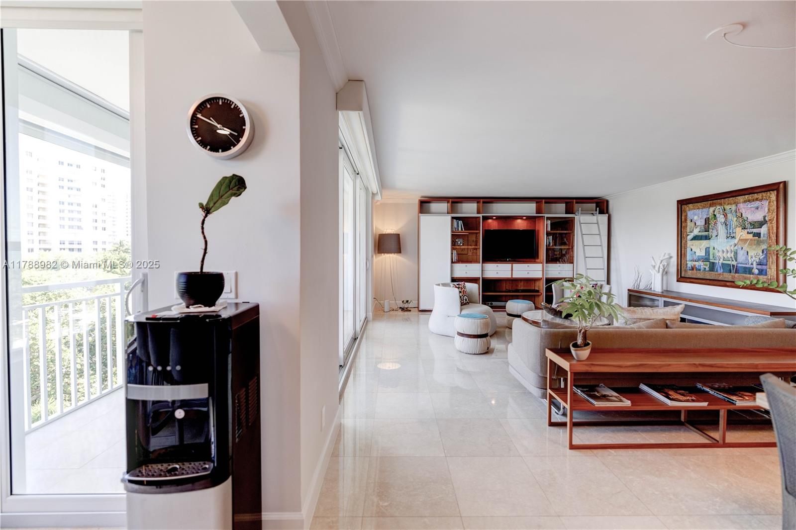 609 Ocean Drive, Unit 6H Key Biscayne, FL 33149 - Photo 8 of 32 a living room with furniture and a flat screen tv