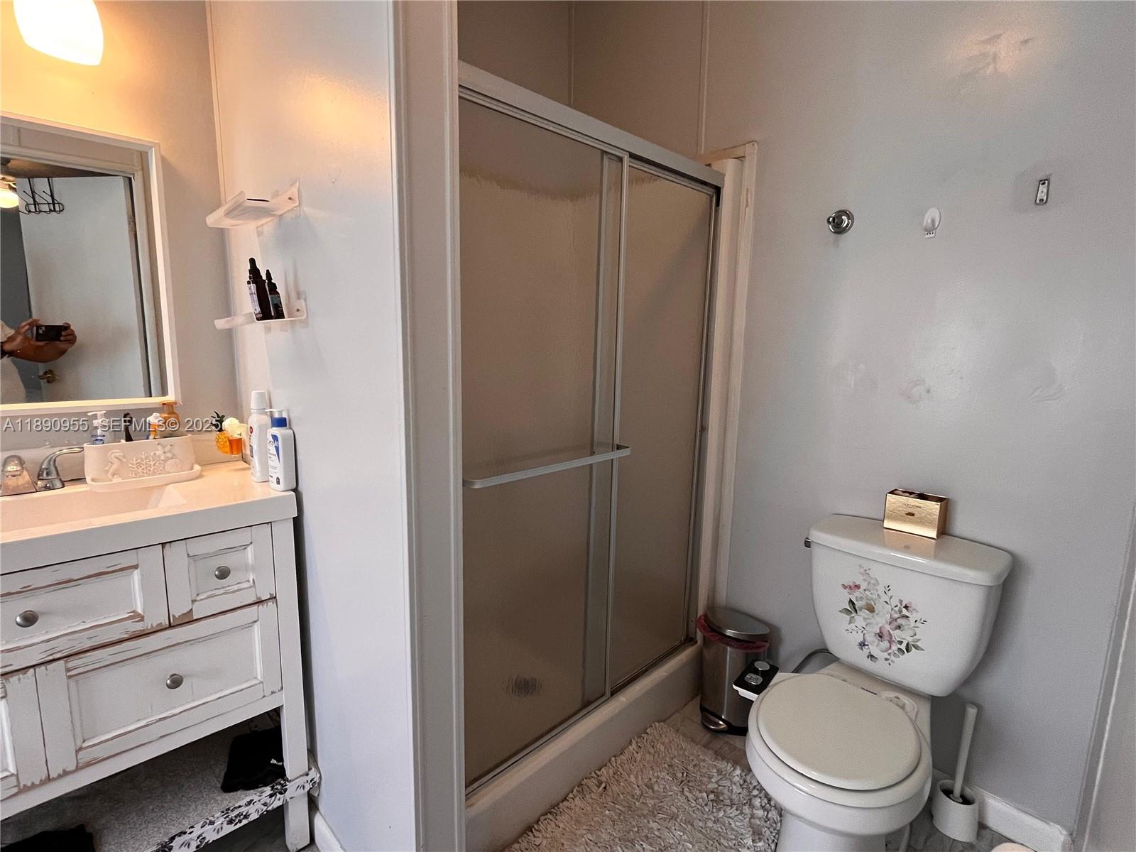 909 Southwest 131st Way Davie, FL 33325 - Photo 11 of 36 a bathroom with a granite countertop toilet sink and shower
