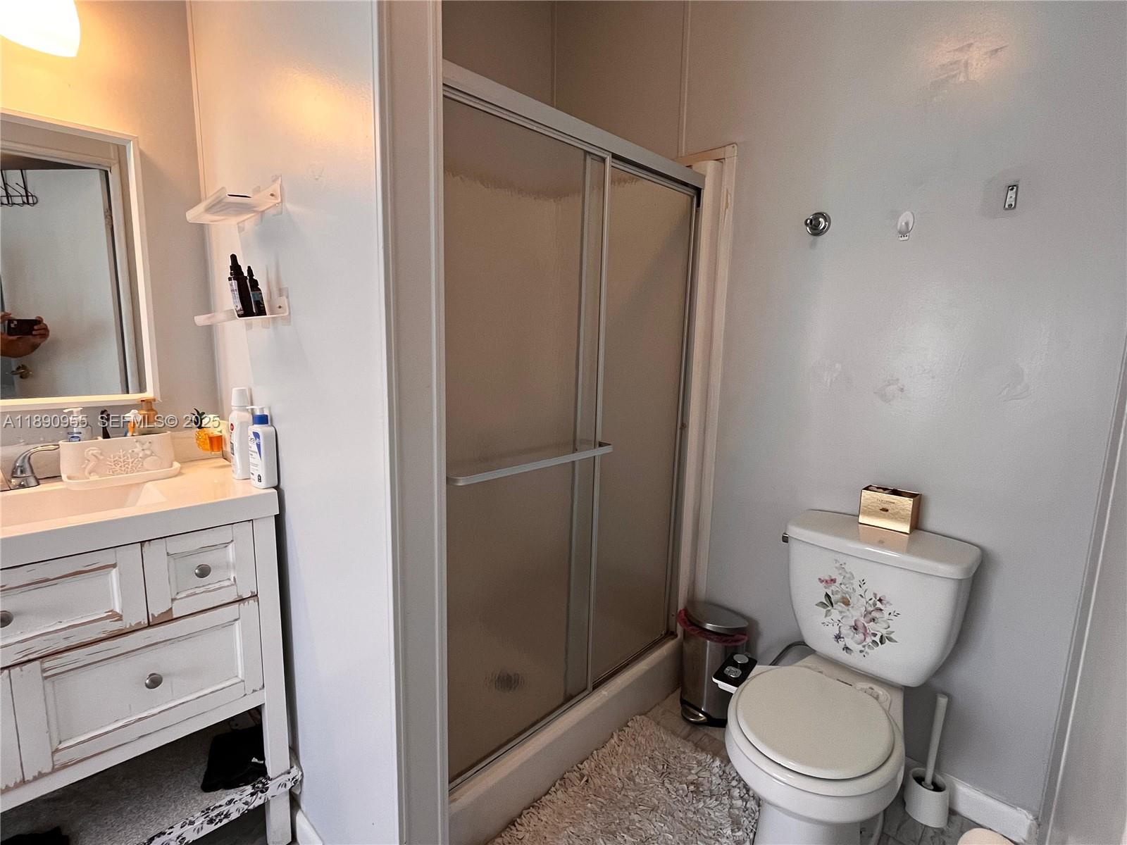 909 Southwest 131st Way Davie, FL 33325 - Photo 13 of 36 a bathroom with a granite countertop toilet sink and shower
