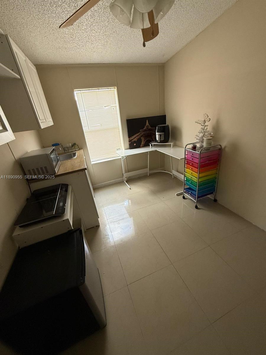 909 Southwest 131st Way Davie, FL 33325 - Photo 23 of 36 a living room with furniture and a table