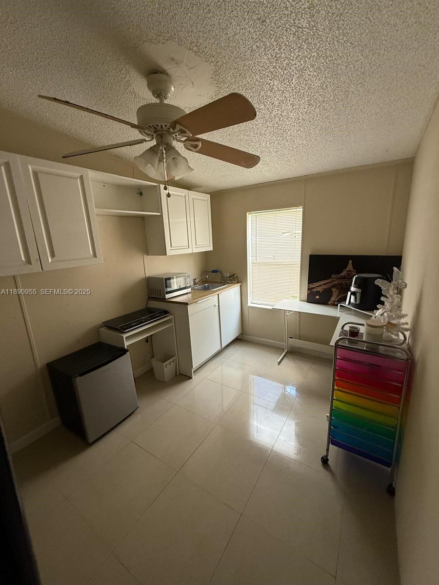 909 Southwest 131st Way Davie, FL 33325 - Photo 24 of 36 a kitchen with stainless steel appliances a stove a sink and a refrigerator