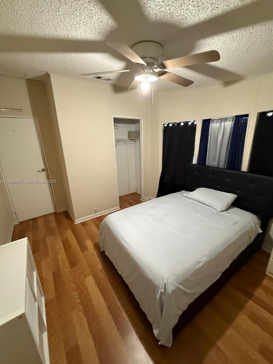 909 Southwest 131st Way Davie, FL 33325 - Photo 26 of 36 a large bed sitting in a bedroom next to a lamp