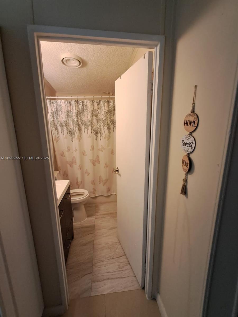 909 Southwest 131st Way Davie, FL 33325 - Photo 28 of 36 a bathroom with a sink and toilet