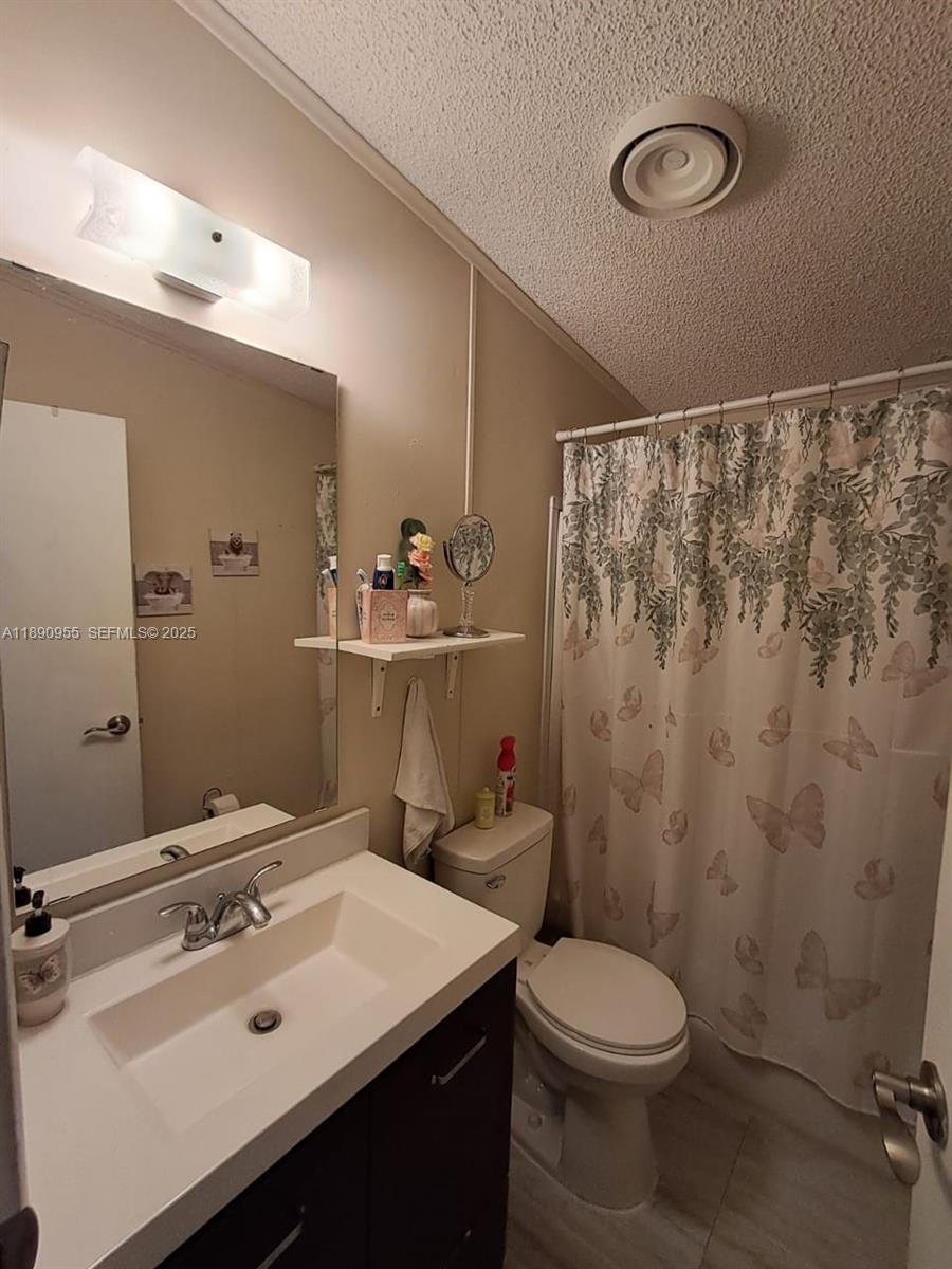 909 Southwest 131st Way Davie, FL 33325 - Photo 29 of 36 a bathroom with a sink a toilet and shower