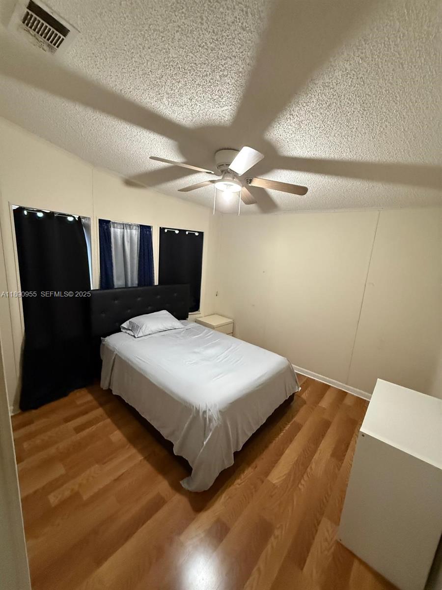 909 Southwest 131st Way Davie, FL 33325 - Photo 31 of 36 a bedroom with a bed and window