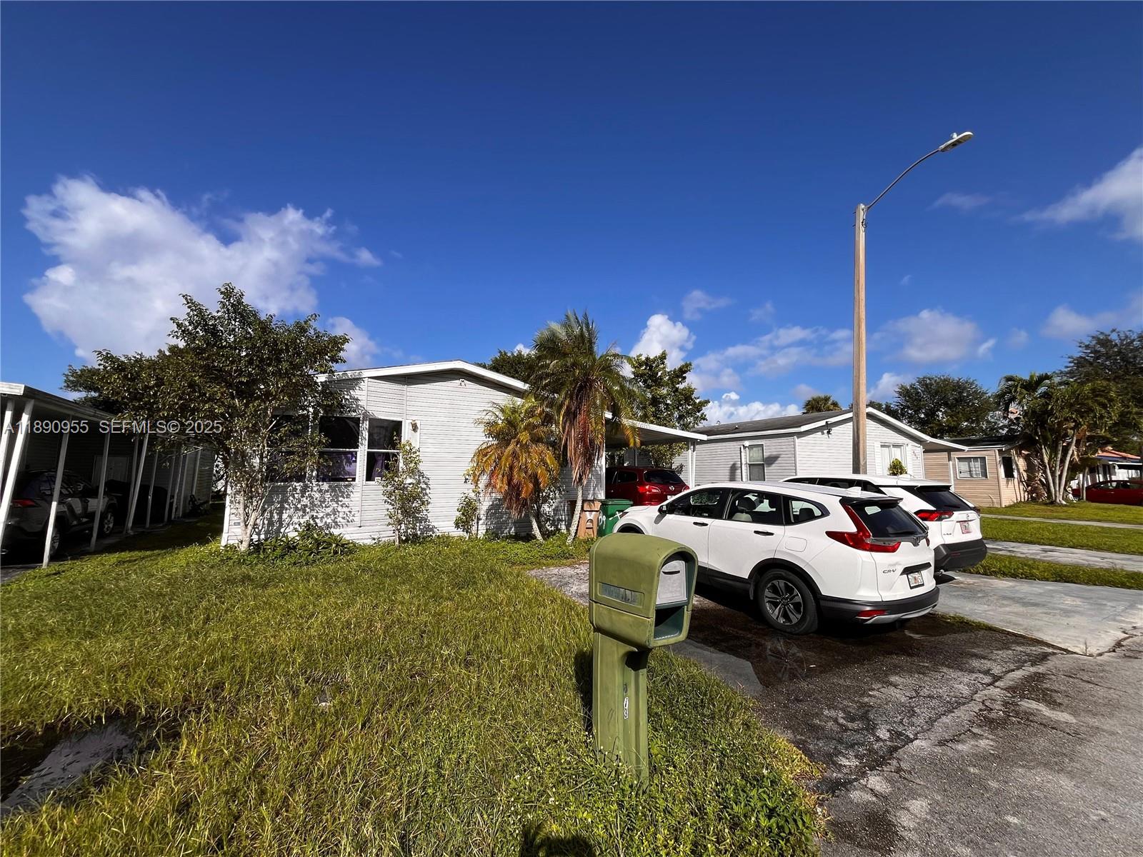 909 Southwest 131st Way Davie, FL 33325 - Photo 32 of 36 a car parked in front of a house