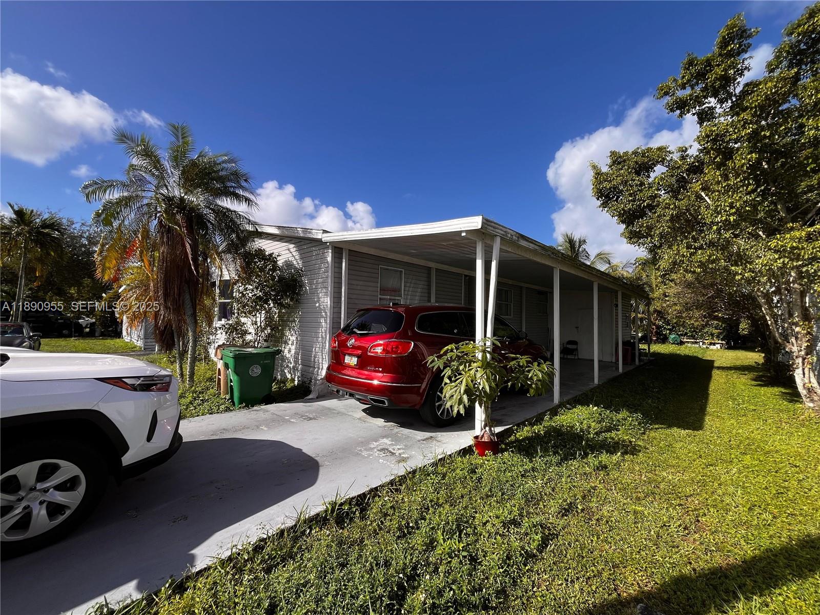 909 Southwest 131st Way Davie, FL 33325 - Photo 34 of 36 a view of a car park in front of a house