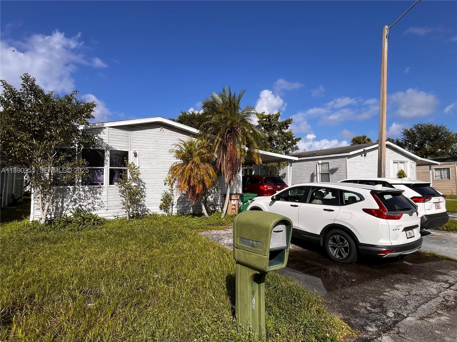 909 Southwest 131st Way Davie, FL 33325 - Photo 35 of 36 a car parked in front of a house
