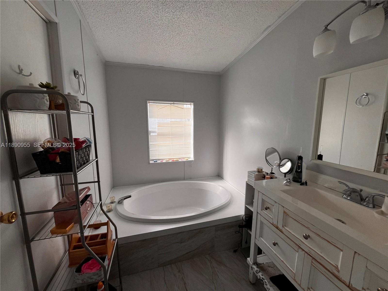 909 Southwest 131st Way Davie, FL 33325 - Photo 36 of 36 a bathroom with a sink and a mirror