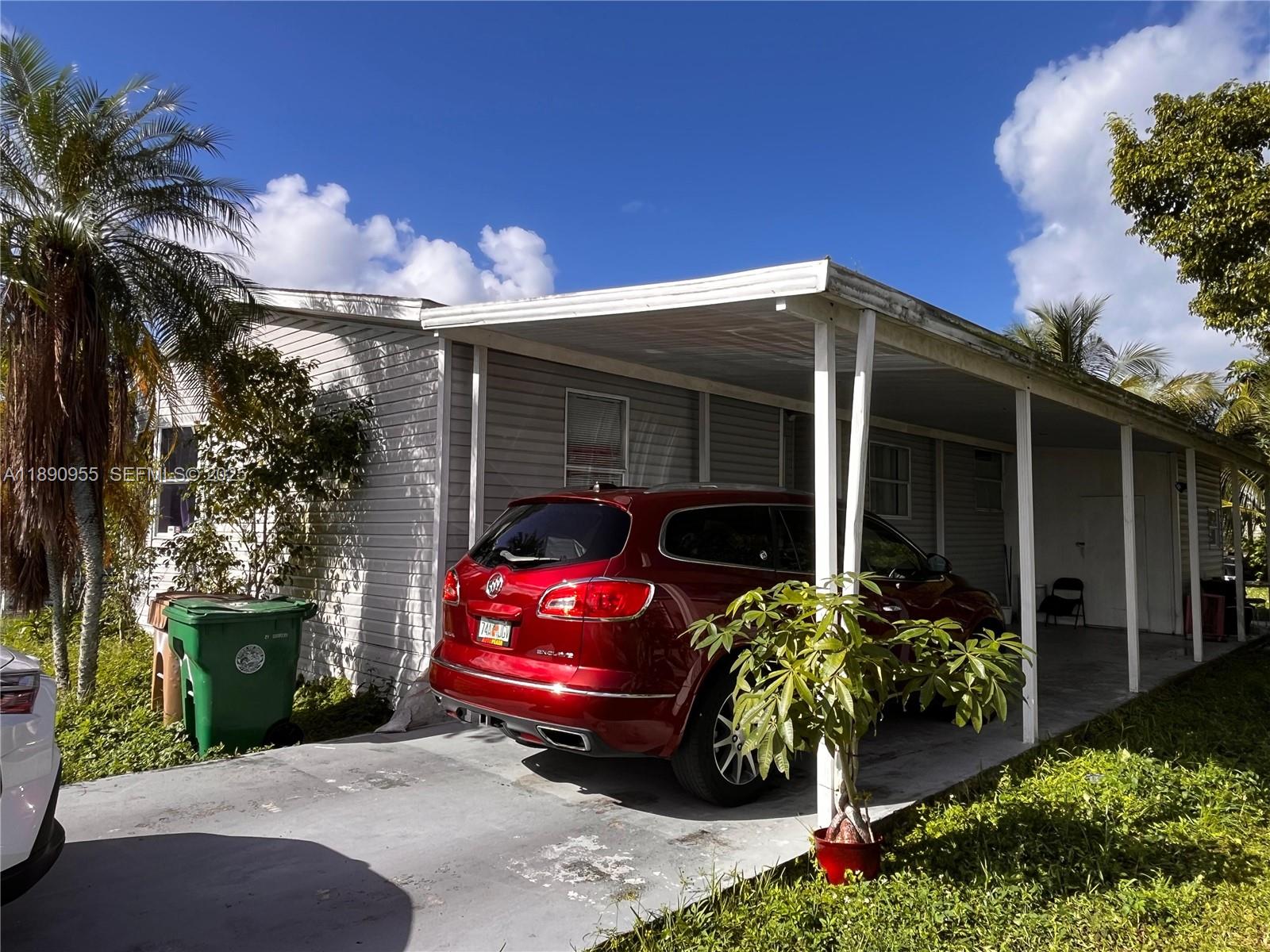 909 Southwest 131st Way Davie, FL 33325 - Photo 7 of 36 a yellow house with outdoor space