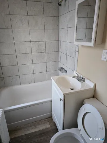 a bathroom with a sink a toilet and bathtub