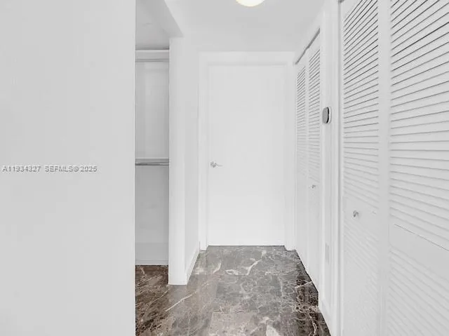a view of a kitchen with stainless steel appliances granite countertop white cabinets and a sink