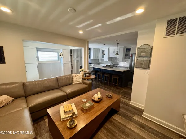 a kitchen that has a lot of cabinets in it and wooden floors