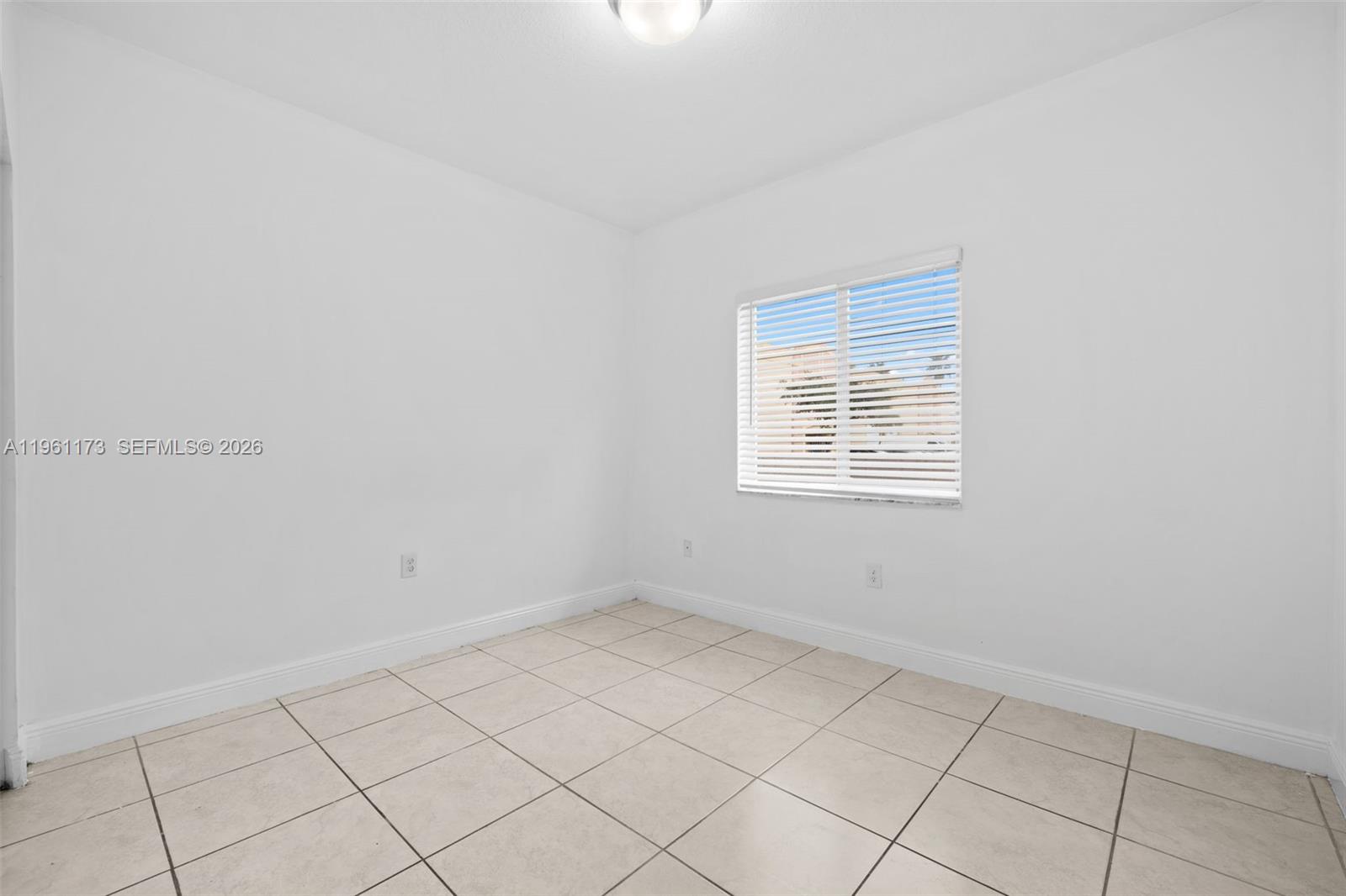 2437 West 78th Street, Unit 104 Hialeah, FL 33016 - Photo 12 of 21 a view of an empty room with a window