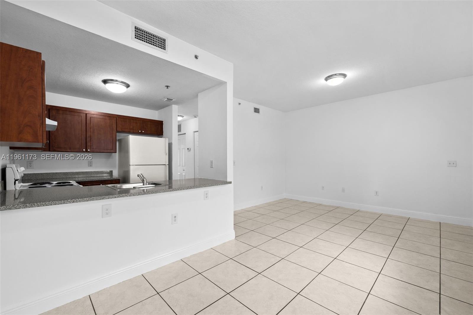 2437 West 78th Street, Unit 104 Hialeah, FL 33016 - Photo 6 of 21 a kitchen with stainless steel appliances a sink a stove a refrigerator a sink and cabinets